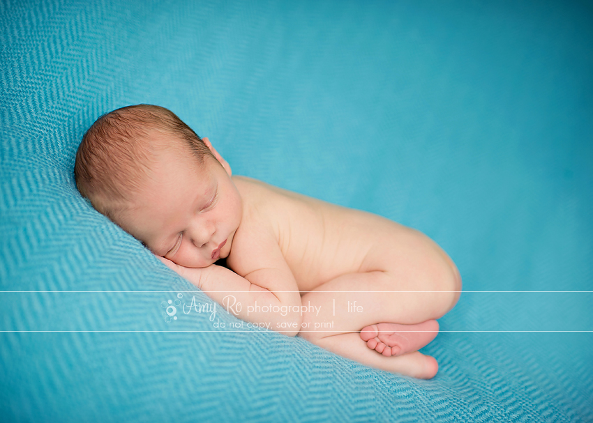 Newborn boy on blue blanket