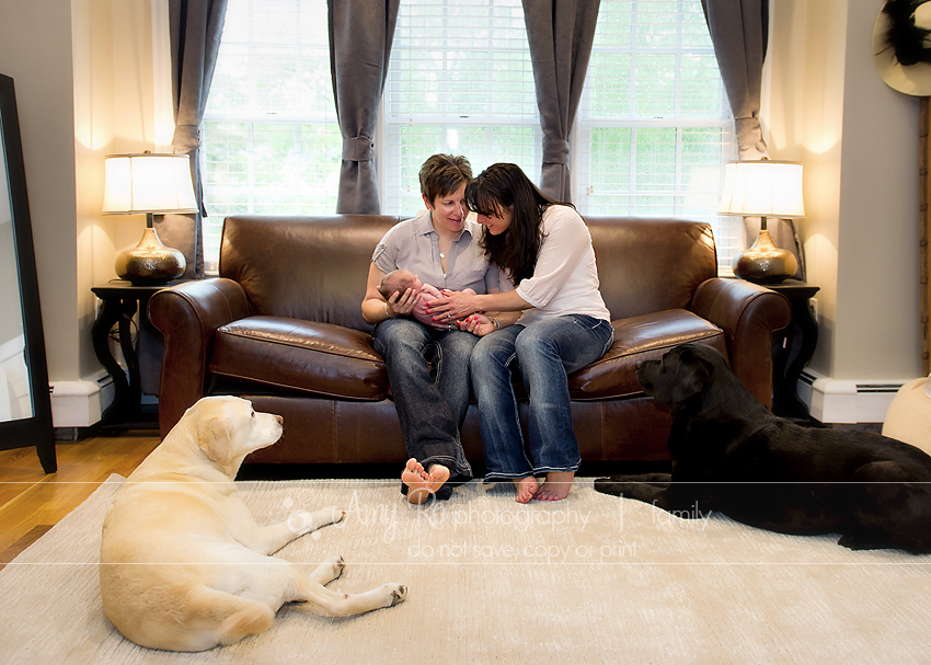 Lesbian couple with beautiful newborn and dogs