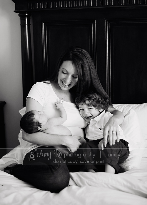 Family shot with mom, newborn and sibling on bed, Massachusetts newborn photography