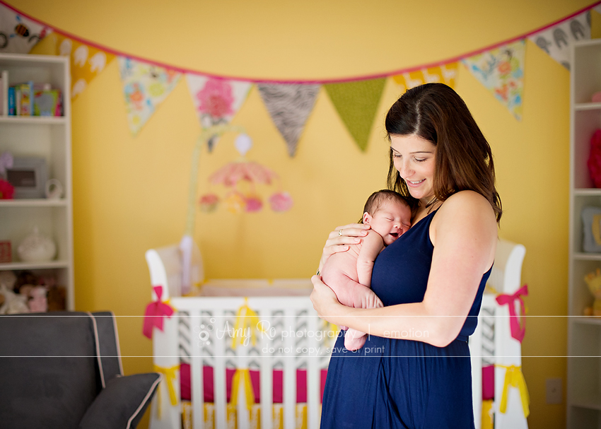 Mom holding newborn, yellow and pink nursery, Massachusetts Newborn Photography