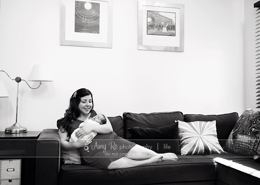 Mother on couch with newborn baby girl lifestyle