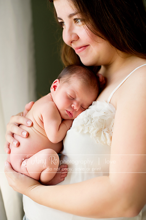 Mother and newborn shot looking out of window