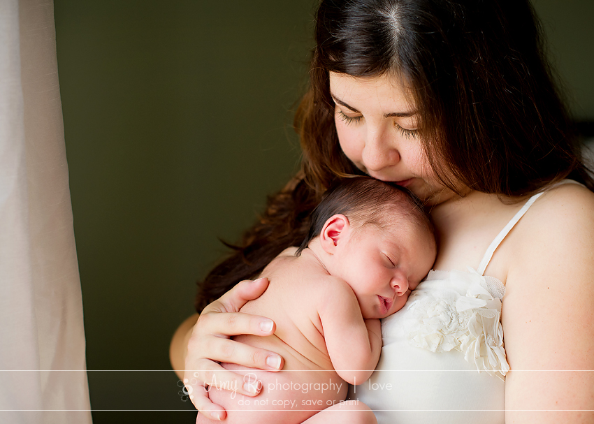 Mother kissing newborn