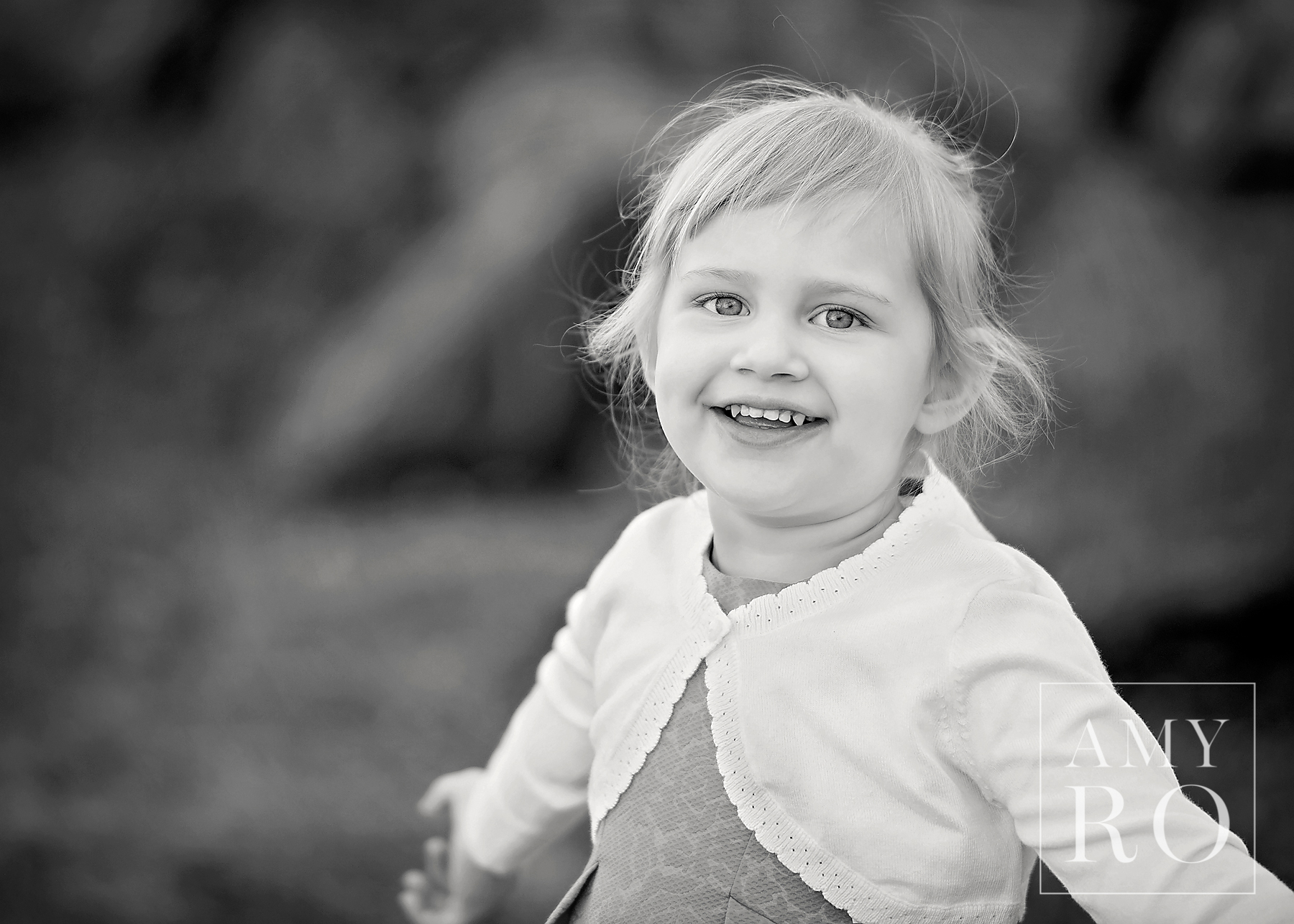 Black and white image of little toddler girl laughing during a family photography session in Massachusetts