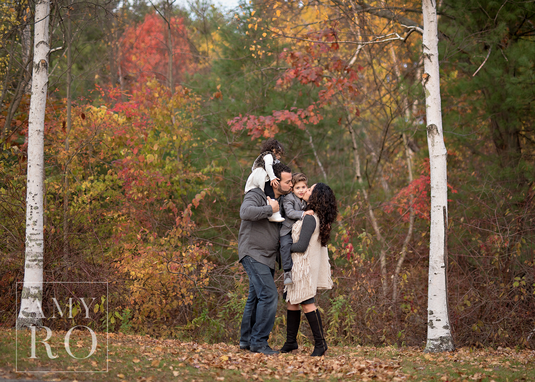 Family kissing under the birch trees during a family session in Rhode Island