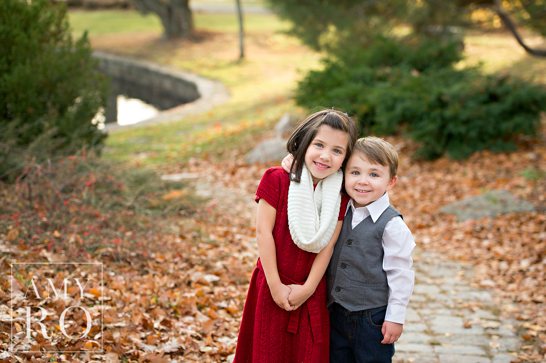 Color image of siblings during the fall at Roger Williams park family photo session