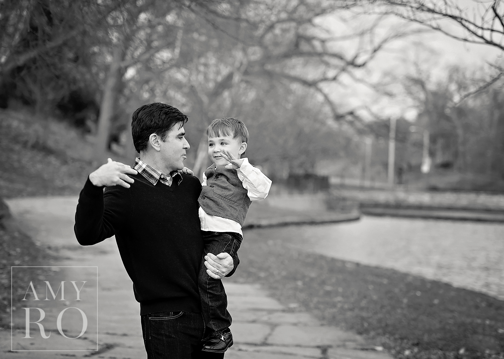Black and white image of father and son fist bumping in Roger Williams Park Rhode Island