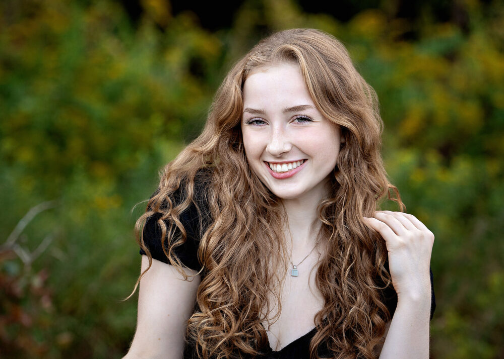 Laughing senior girl from Cumberland High School at the beach in Rhode Island