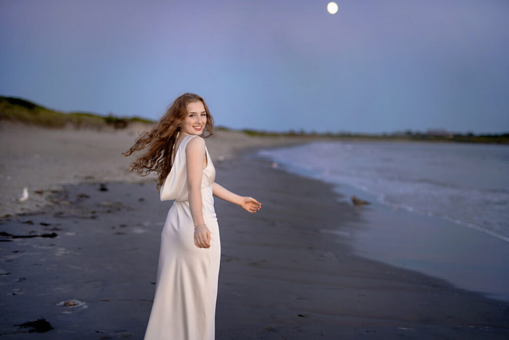 Spinning on the beach during senior session at sunset in Newport RI