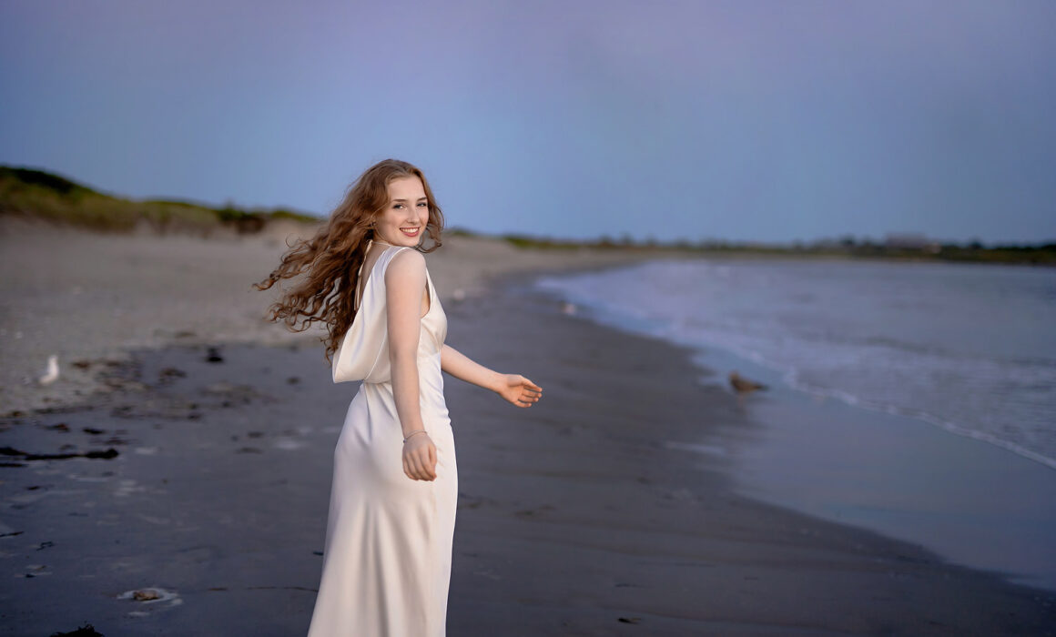 Spinning on the beach during senior session at sunset in Newport RI