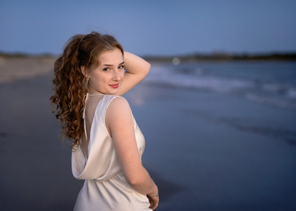 Senior girl Cumberland High School holding hair up on the beach in Massachusetts
