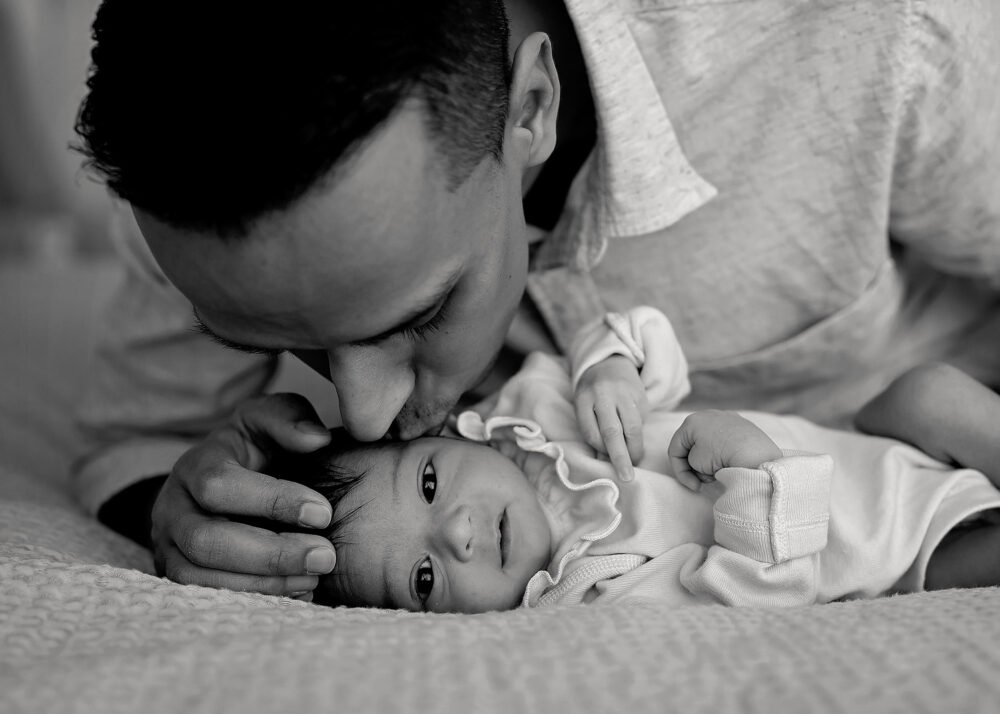 Dad kissing baby during newborn photo session in Newport RI