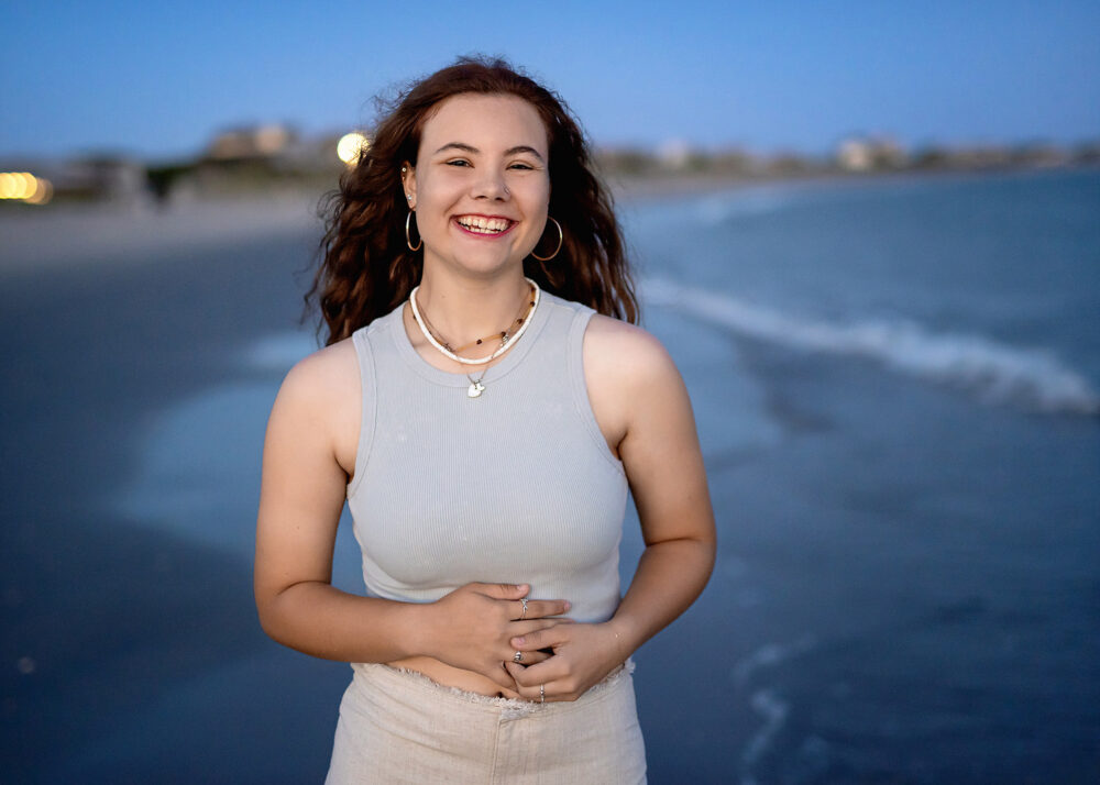 Laughing senior girl photo taken on the beach at sunset in Narragansett Rhode Island