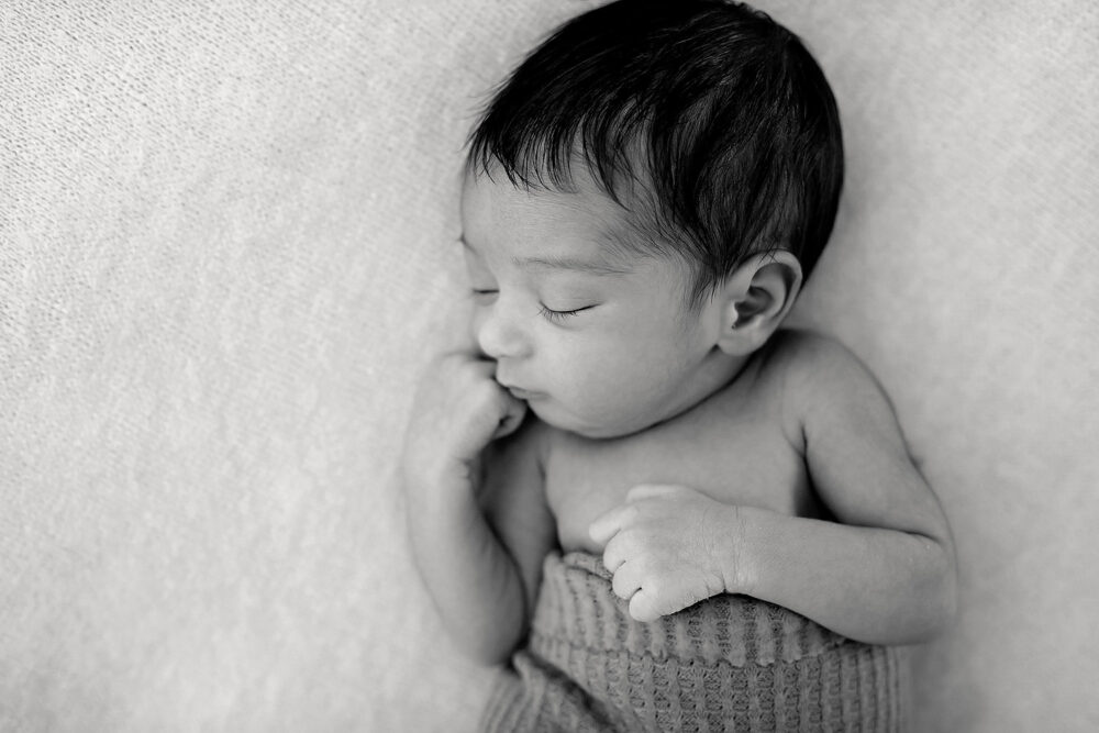 Overhead of sleeping newborn girl during photos in Massachusetts