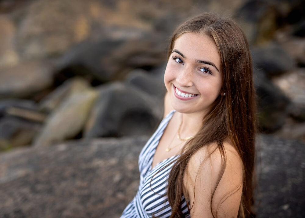 Smiling senior LaSalle student at the beach in Rhode Island for photos