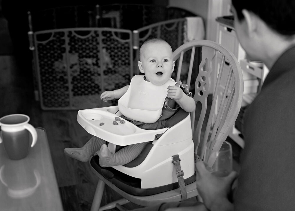 Baby in highchair during lifestyle family session in Providence RI