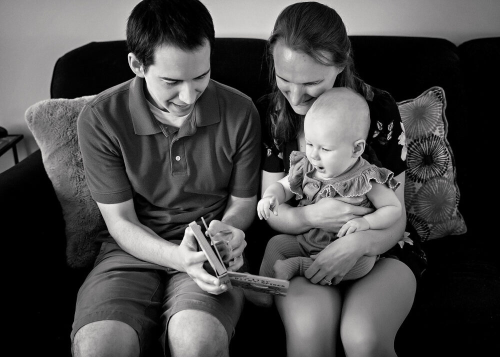 Dad reading to baby during on location family session with baby in Rhode Island