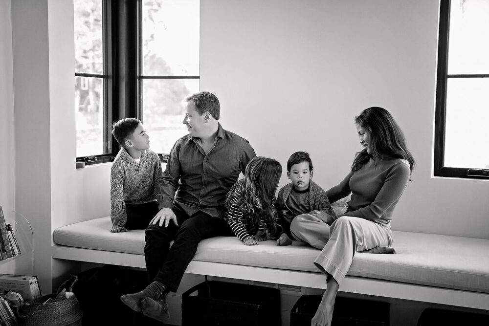 Family laughing on window seat east side of providence family session