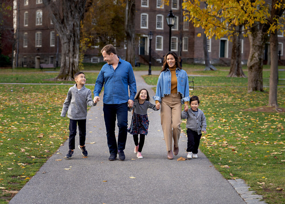 Family walking on Brown University campus during family session