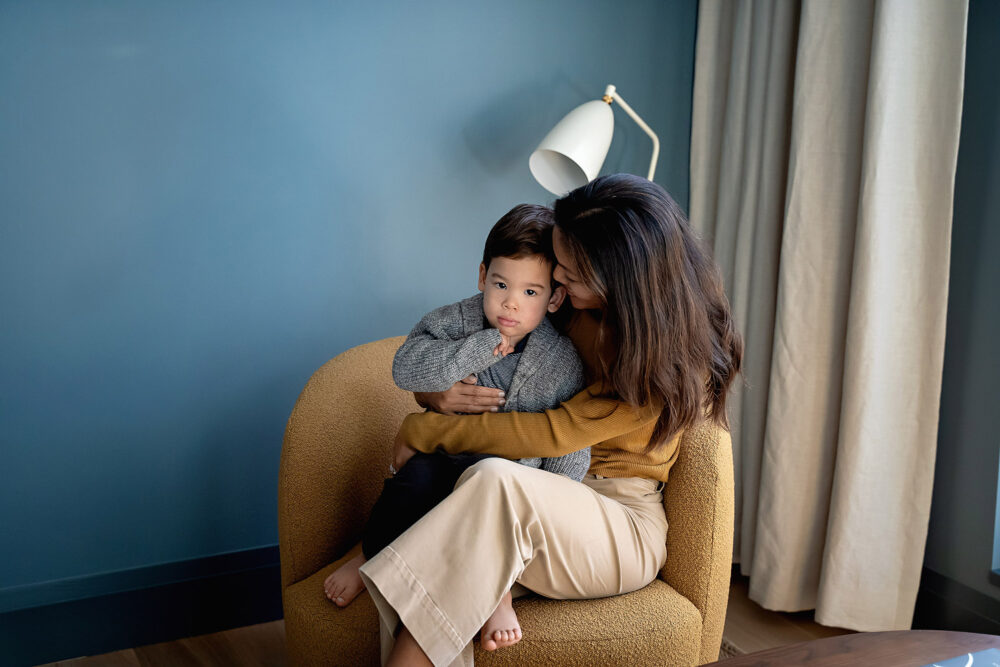 Mom and son snuggled in study blue walls Providence RI
