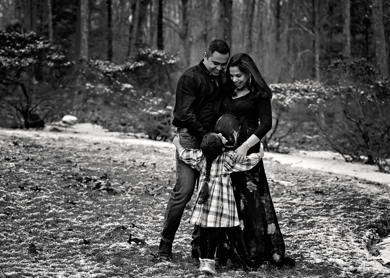 Mom dad and daughter in backyard maternity session near East Greenwich RI