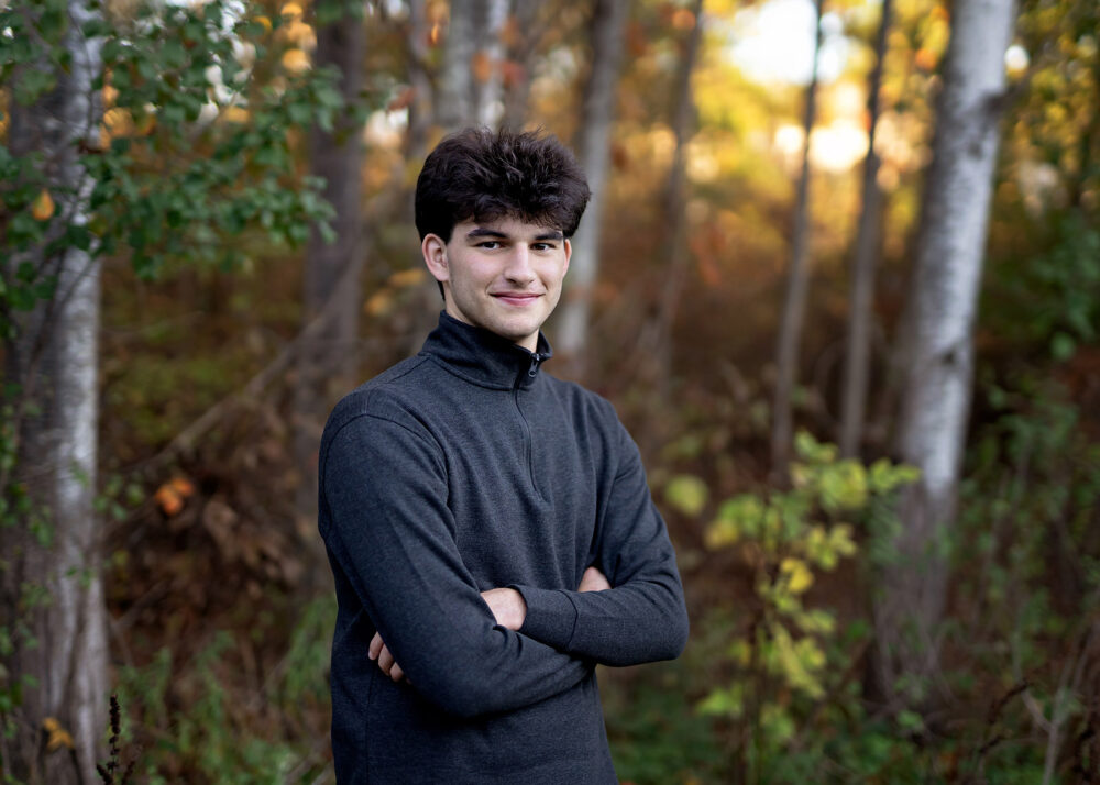 Teen senior boy pose fall color woods Cumberland RI monastery