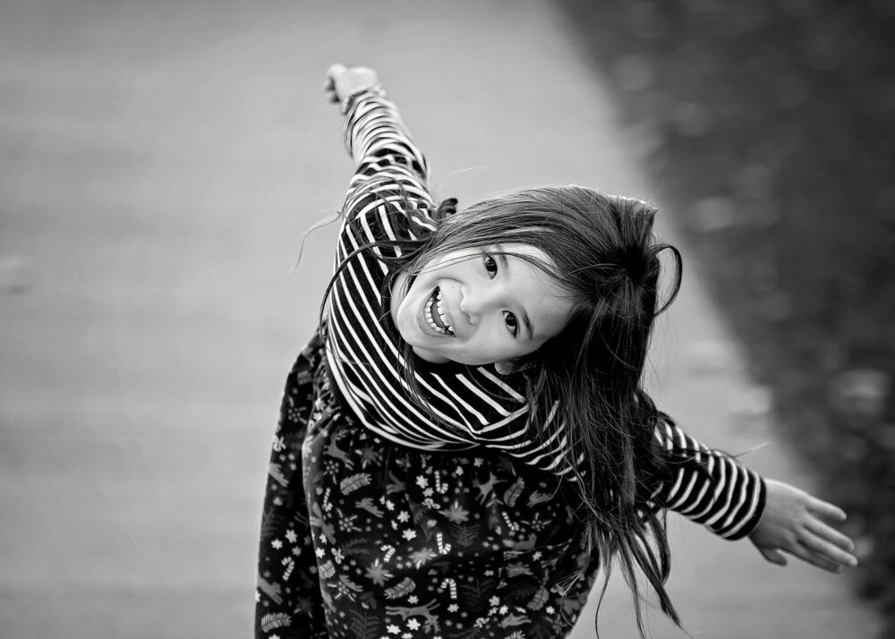Young girl playing laughing during on location family session