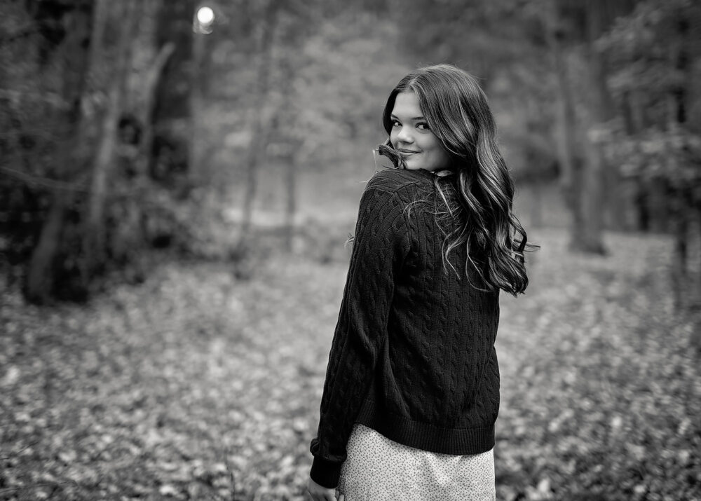Senior girl looking over her shoulder during senior portraits Rhode Island
