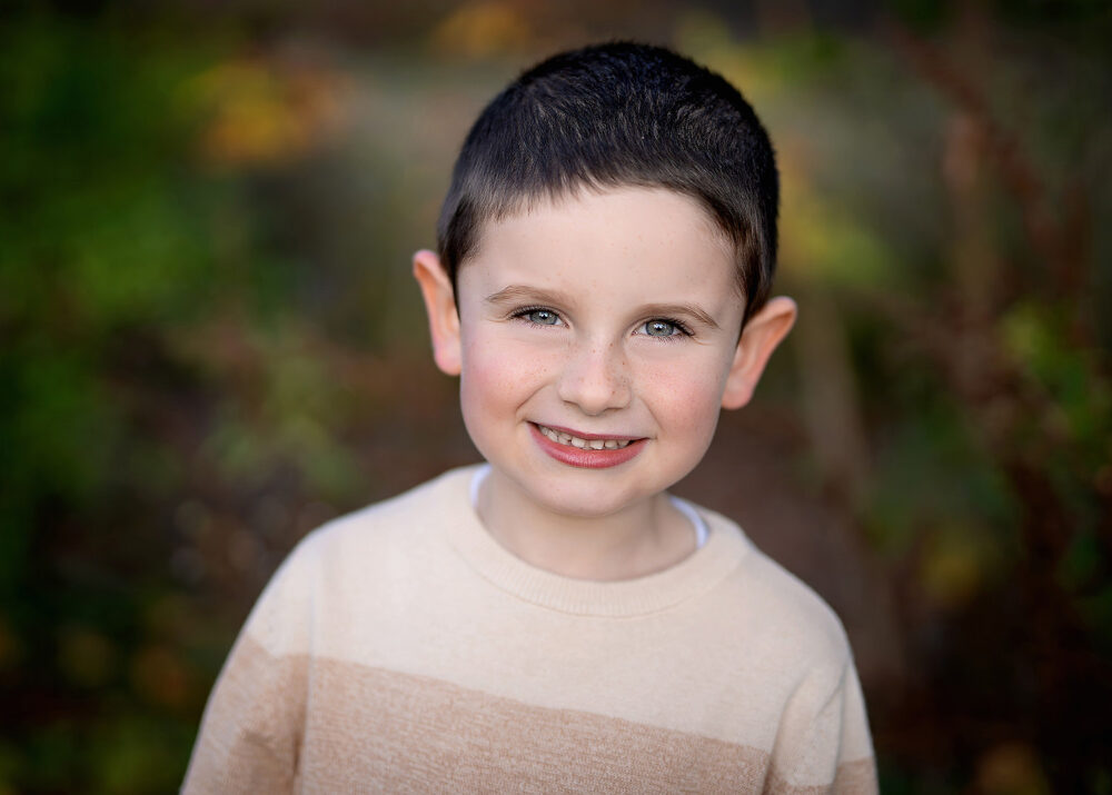 Young boy with blue eyes in a fall family photo session Cumberland Rhode Island