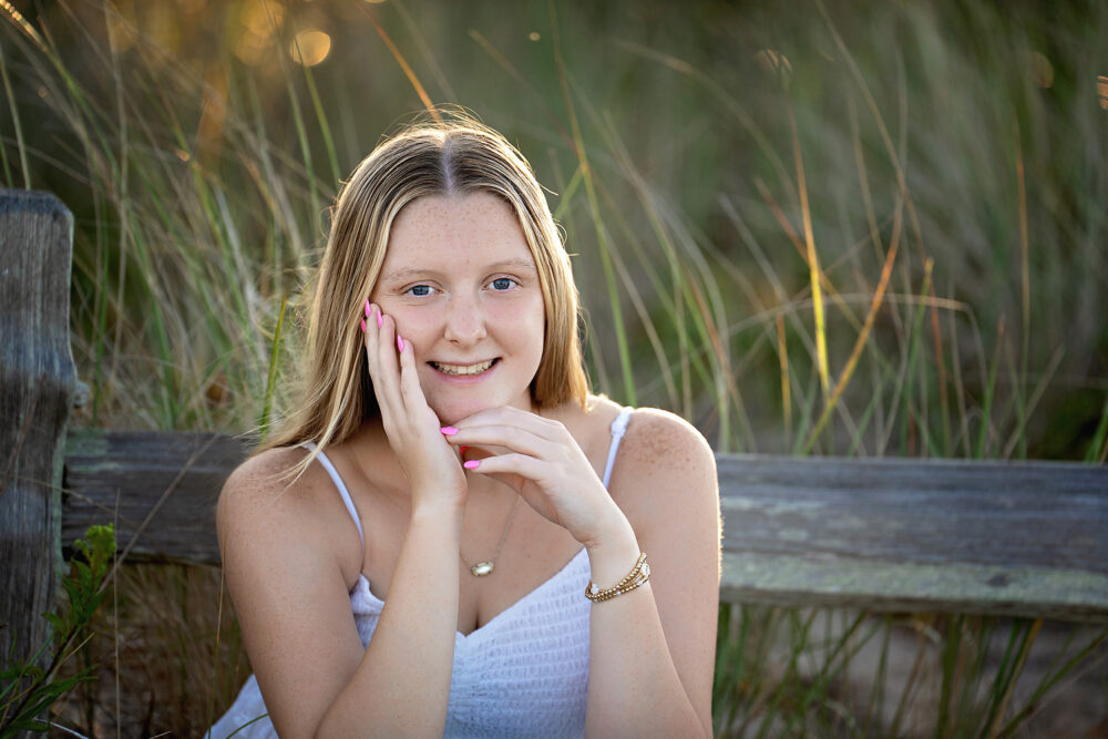 Portrait of senior girl in the dunes at Napa Tree Point in Rhode Island