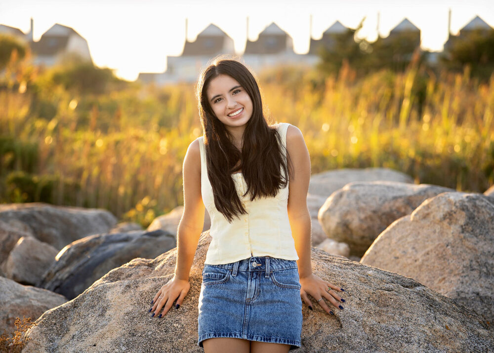 Senior portraits at Scarborough Beach Rhode Island beach rocks and tall beach grasses
