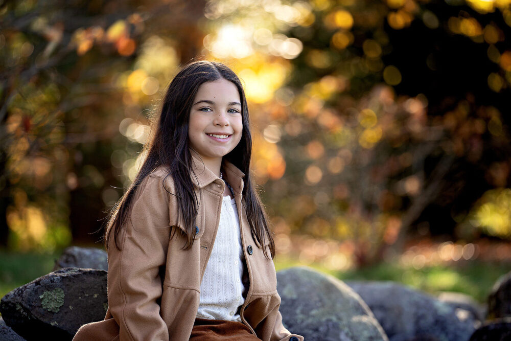 Brown haired girl backlit woods photos family session Blackstone Boulevard Providence