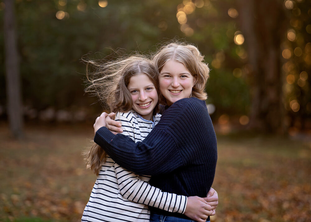 Teenage sibling sisters in the fall during photos in Barrington Rhode Island
